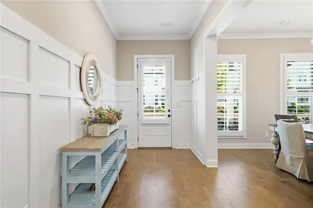 a dining room with furniture and wooden floor