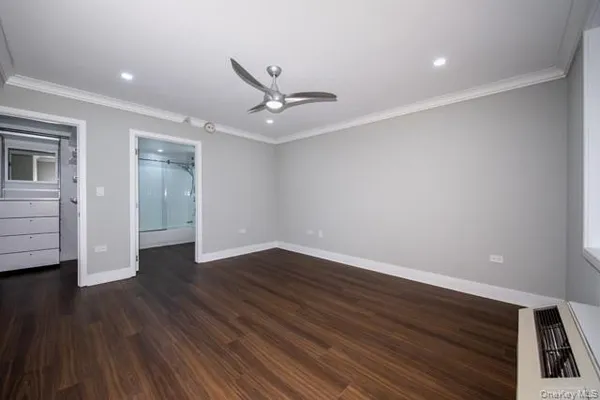 a view of an empty room with wooden floor
