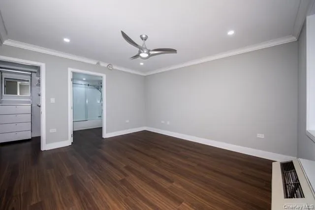 a view of an empty room with wooden floor