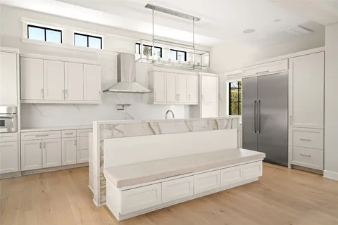 a kitchen with stainless steel appliances cabinets and a window