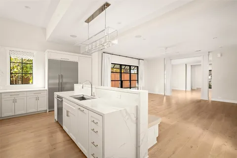 a view of a kitchen with sink large windows and wooden floor