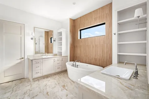 a spacious bathroom with a granite countertop sink and a mirror