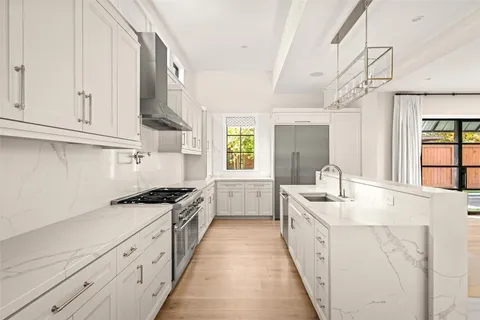 a kitchen with granite countertop a sink stove and cabinets
