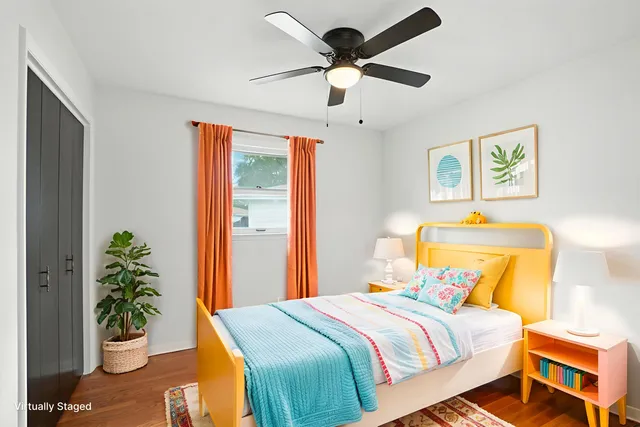 a bedroom with a bed and a potted plant