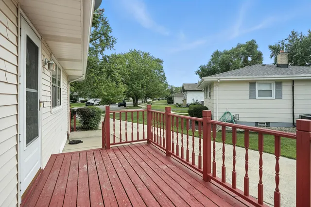 a view of a wooden deck and a yard