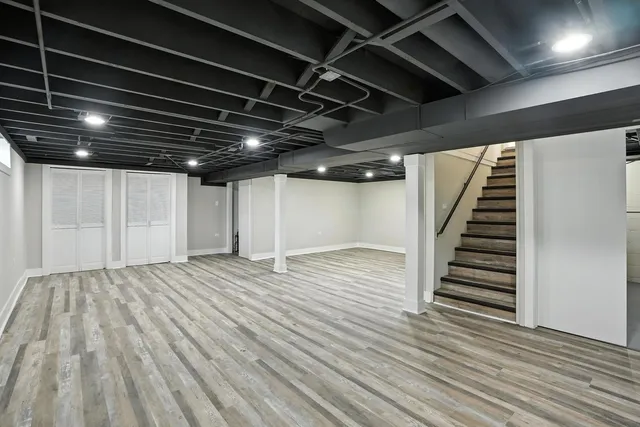 a view of an empty room with wooden floor