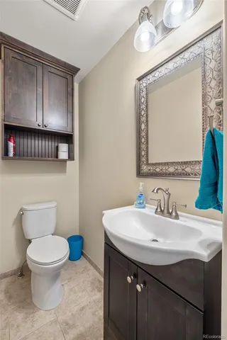 a bathroom with a toilet a sink and mirror