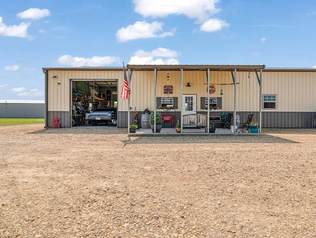a view of swimming pool with outdoor seating and yard in back
