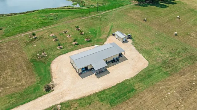 an aerial view of a house with a yard
