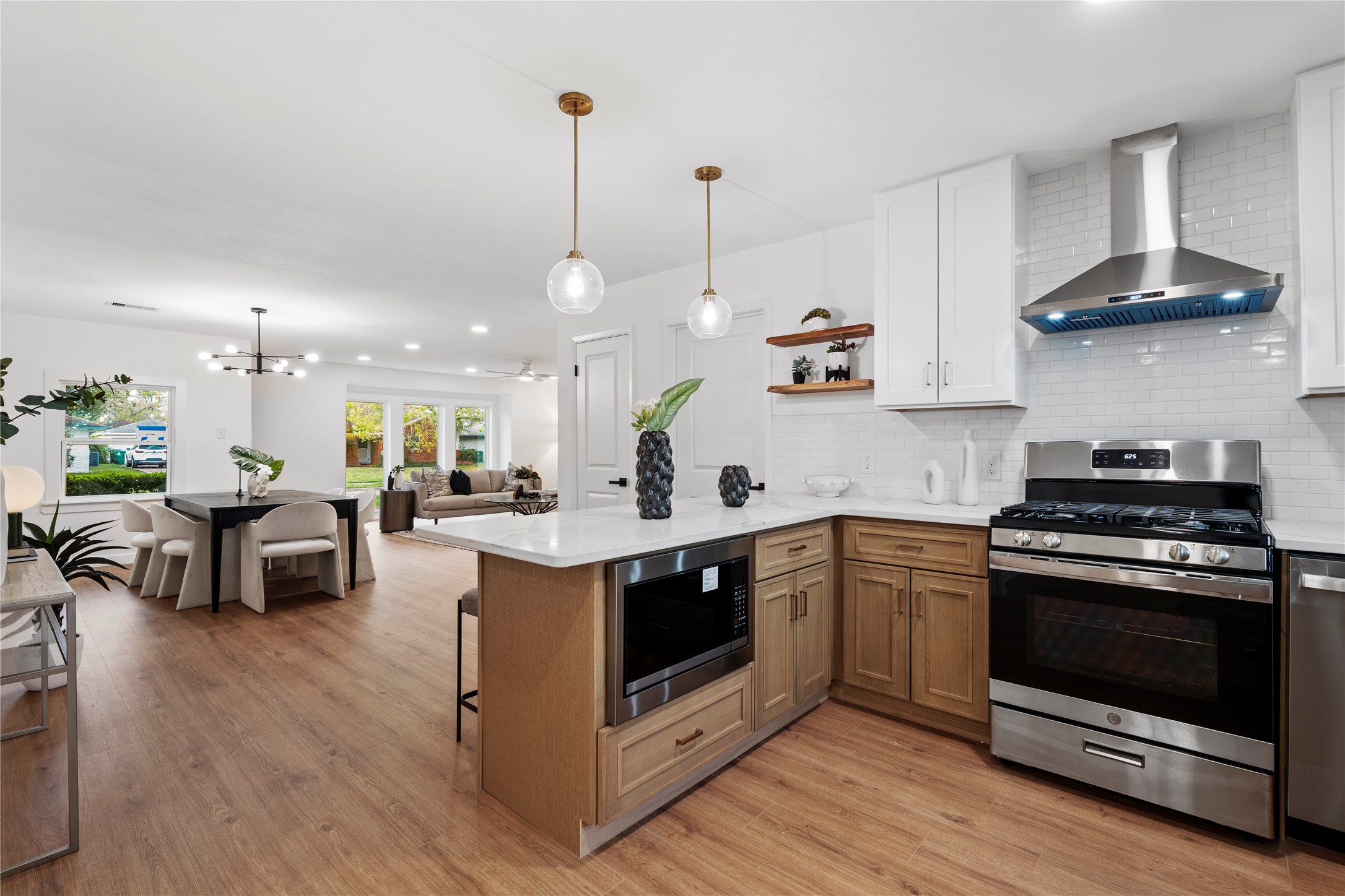 5023 Redstart Street Houston, TX 77035 - Photo 1 of 34 This expansive view highlights the seamless transition from the kitchen to the main living area, featuring high-end stainless steel appliances and a built-in microwave drawer.