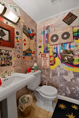 a bathroom with a toilet a sink and a shower curtain