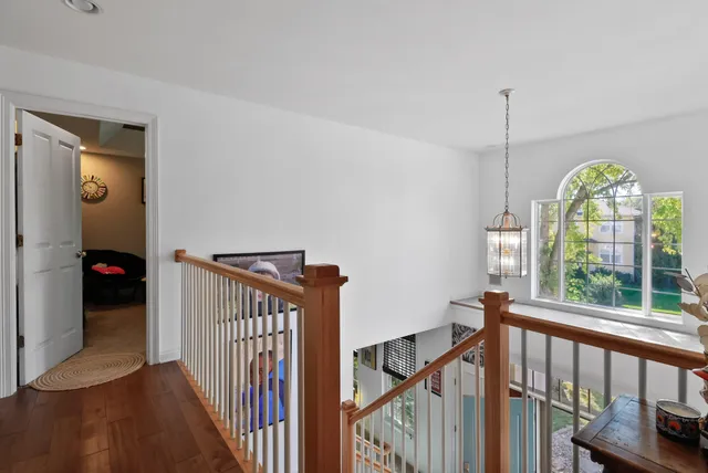 a view of an entryway with wooden floor and windows