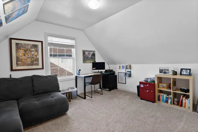 a living room with furniture and a book shelf
