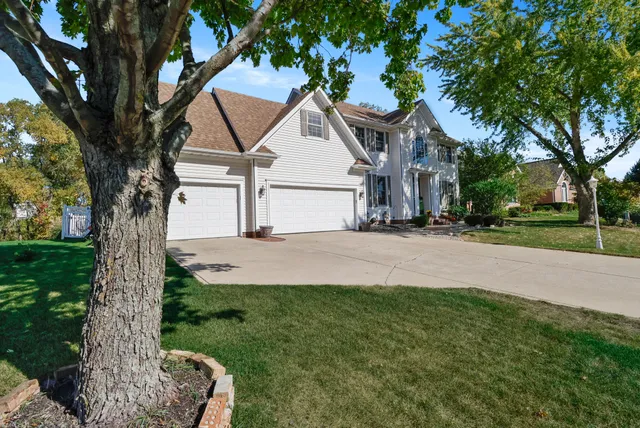 a view of a house with a tree in the yard