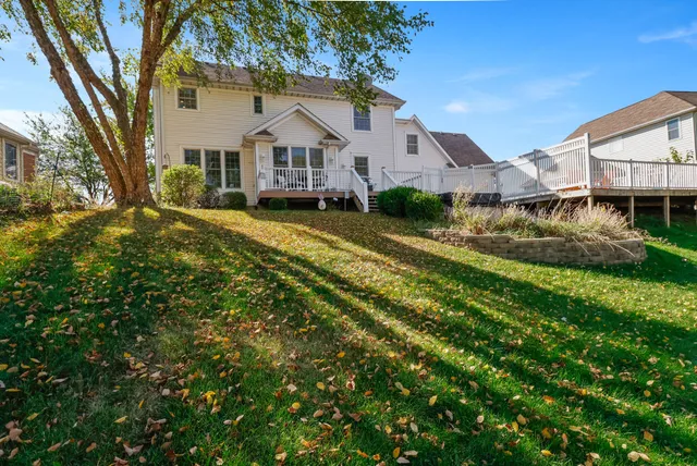 a front view of a house with a yard and large trees