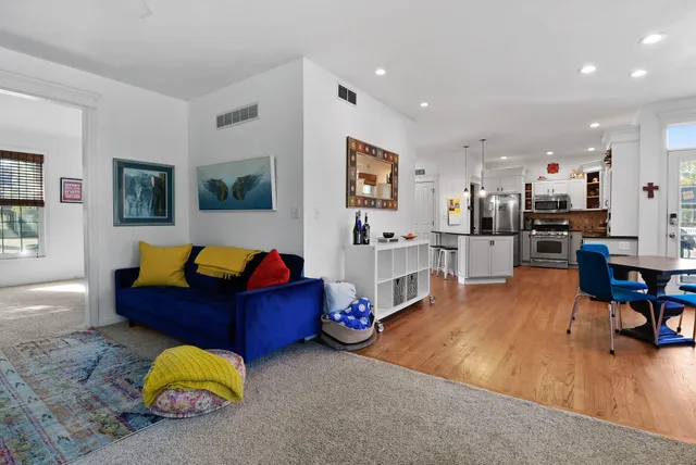 a living room with furniture and kitchen view