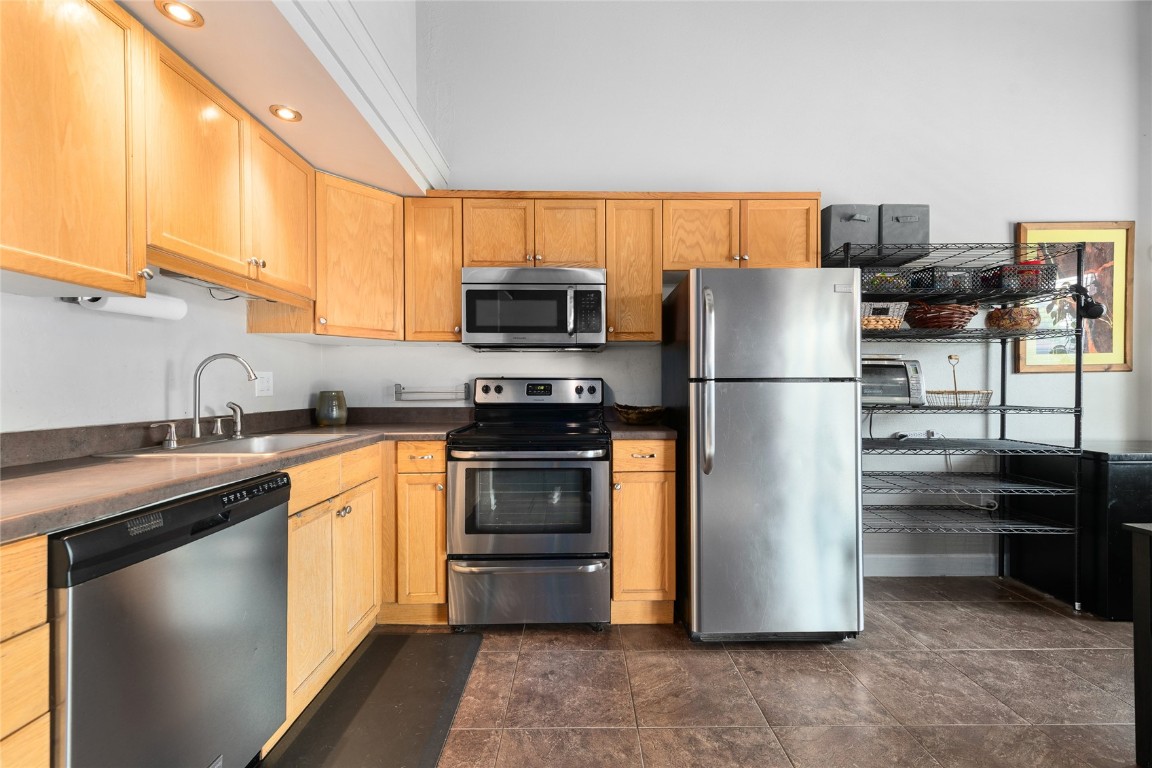 1355 Walton Creek Road, Unit 20 Steamboat Springs, CO 80487 - Photo 17 of 43 a kitchen with stainless steel appliances granite countertop a refrigerator and a sink