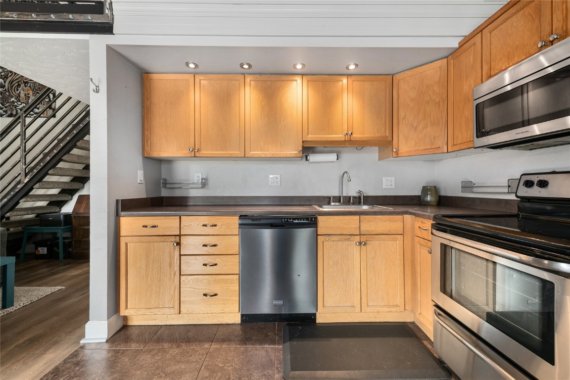 1355 Walton Creek Road, Unit 20 Steamboat Springs, CO 80487 - Photo 19 of 43 a kitchen with stainless steel appliances granite countertop a stove and a microwave