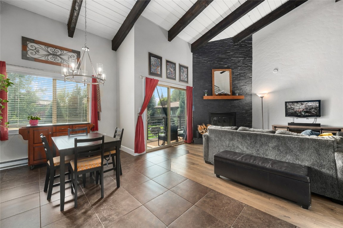 1355 Walton Creek Road, Unit 20 Steamboat Springs, CO 80487 - Photo 20 of 43 a living room with fireplace furniture and a floor to ceiling window