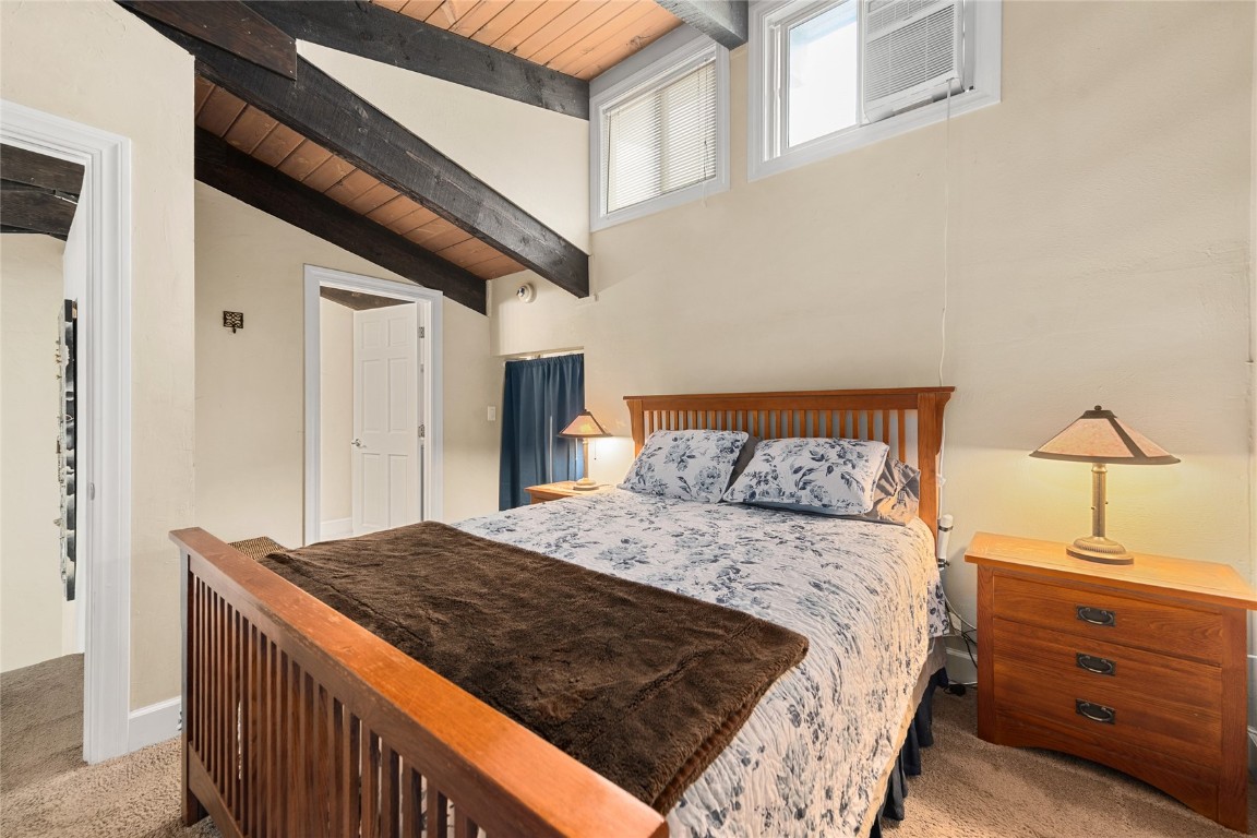 1355 Walton Creek Road, Unit 20 Steamboat Springs, CO 80487 - Photo 21 of 43 a bedroom with a bed and a dresser