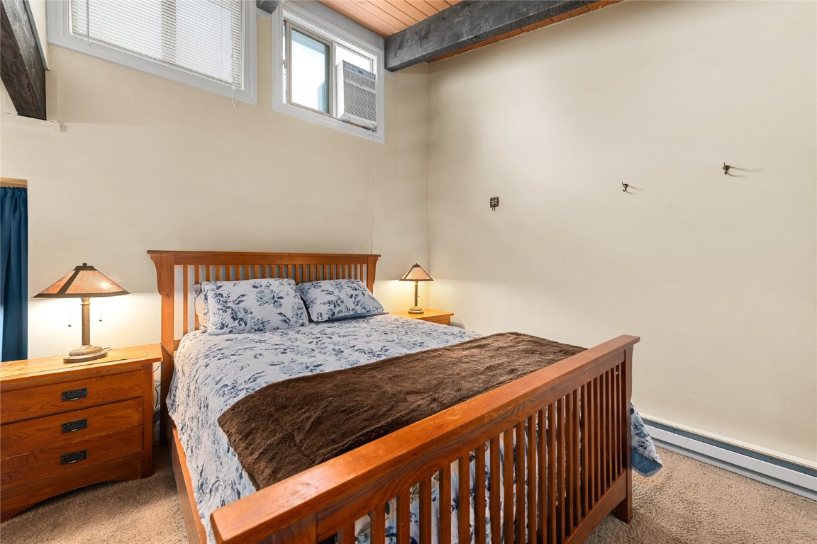 1355 Walton Creek Road, Unit 20 Steamboat Springs, CO 80487 - Photo 22 of 43 a bedroom with a bed and a window
