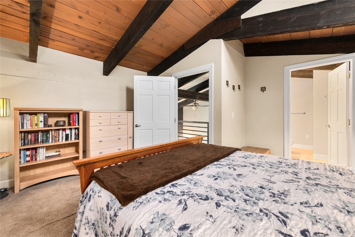 1355 Walton Creek Road, Unit 20 Steamboat Springs, CO 80487 - Photo 23 of 43 a bedroom with a bed and a book shelf