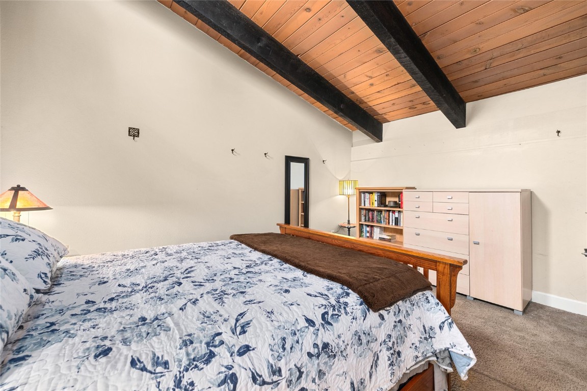 1355 Walton Creek Road, Unit 20 Steamboat Springs, CO 80487 - Photo 24 of 43 a bedroom with a bed and a dresser
