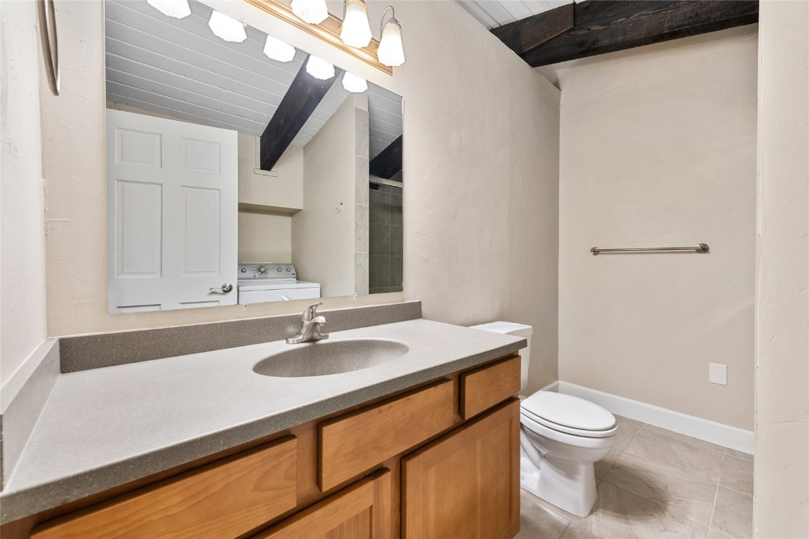 1355 Walton Creek Road, Unit 20 Steamboat Springs, CO 80487 - Photo 25 of 43 a bathroom with a sink toilet a mirror and shower