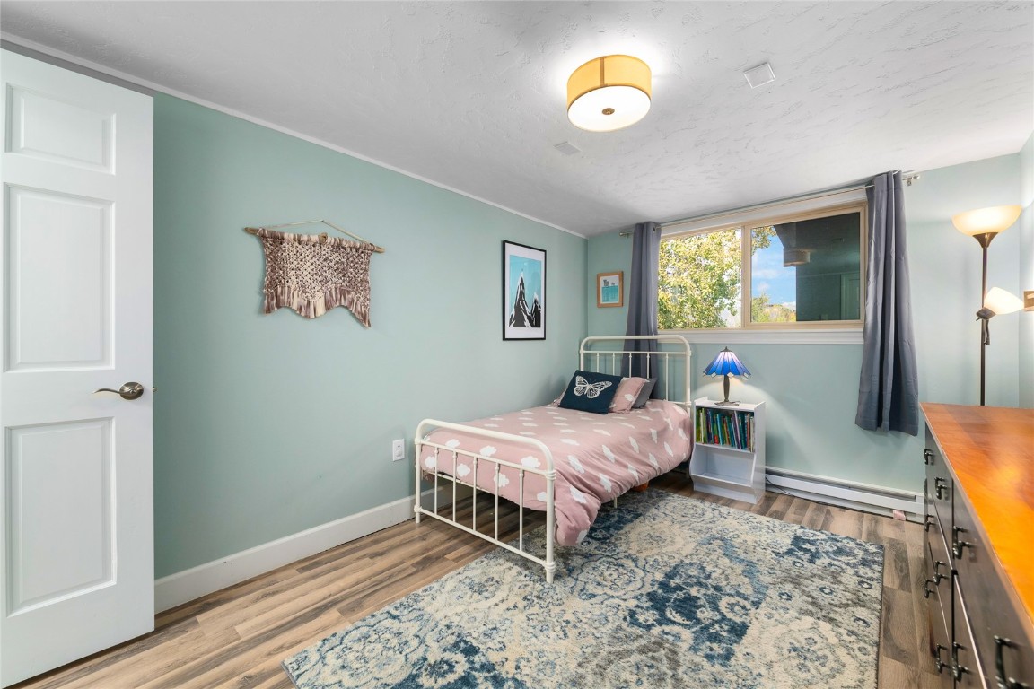 1355 Walton Creek Road, Unit 20 Steamboat Springs, CO 80487 - Photo 28 of 43 a bedroom with a bed window and a rug