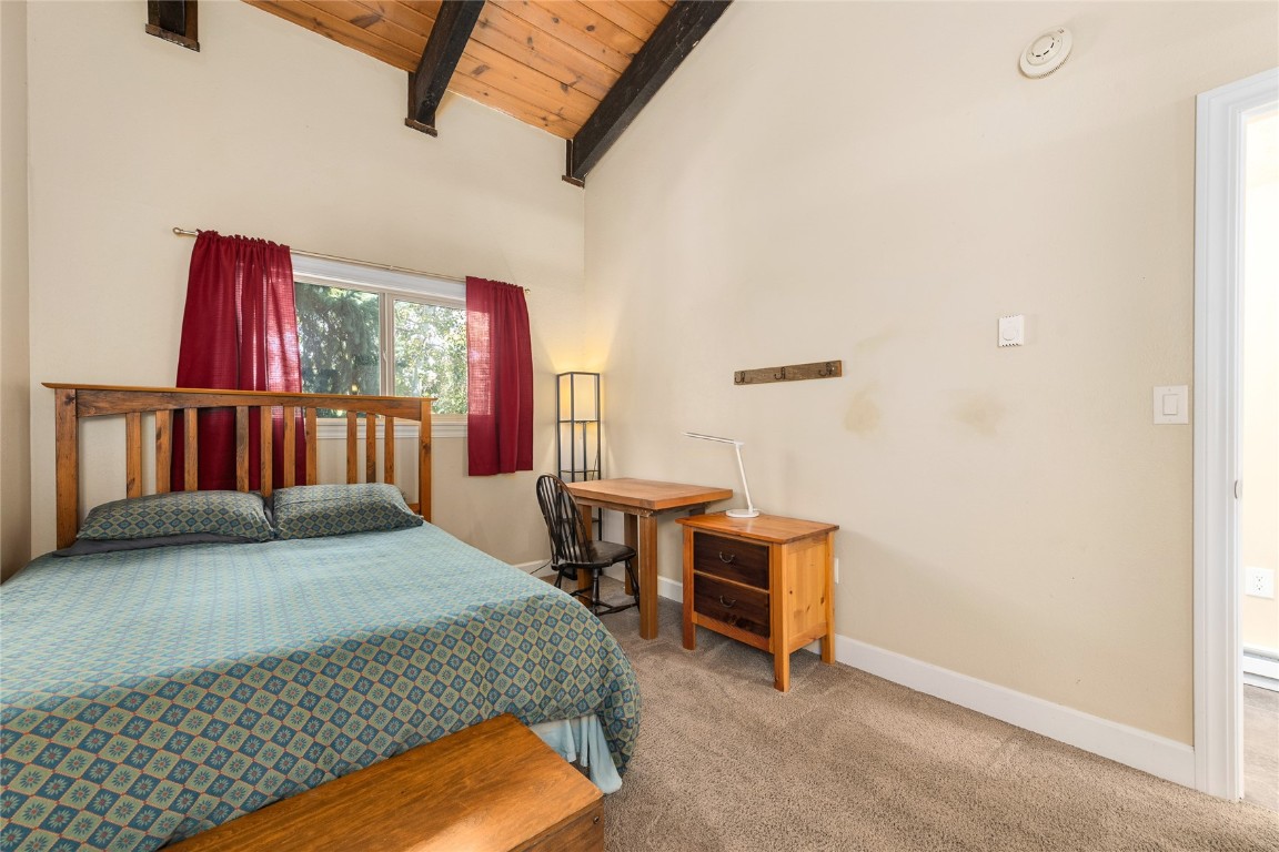 1355 Walton Creek Road, Unit 20 Steamboat Springs, CO 80487 - Photo 32 of 43 a bedroom with a bed and a window