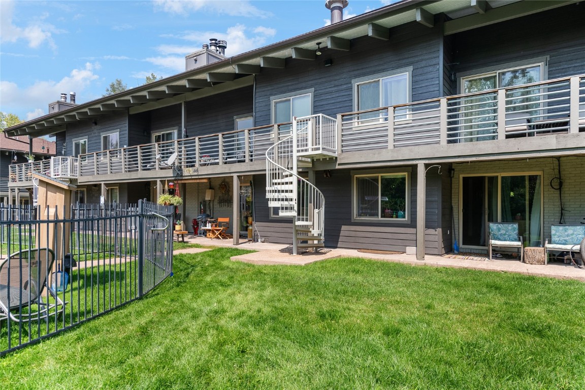 1355 Walton Creek Road, Unit 20 Steamboat Springs, CO 80487 - Photo 35 of 43 a front view of a house with a yard and porch