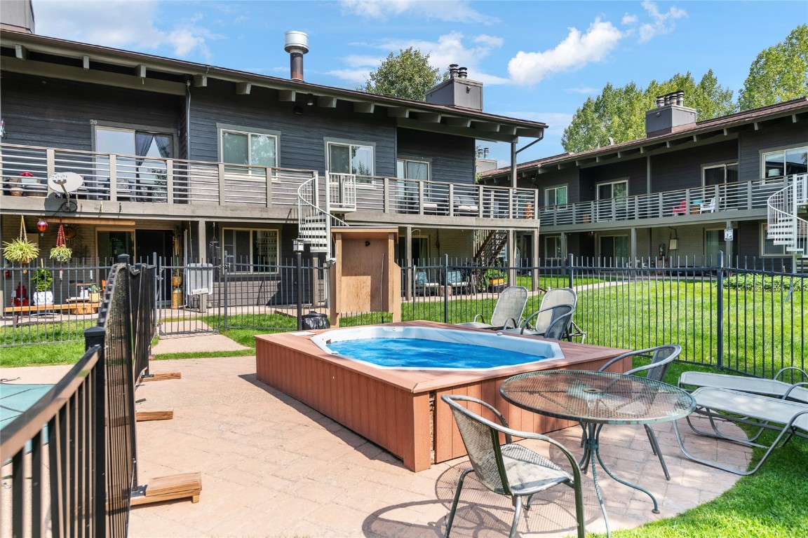 1355 Walton Creek Road, Unit 20 Steamboat Springs, CO 80487 - Photo 37 of 43 a view of a building with a swimming pool and sitting area