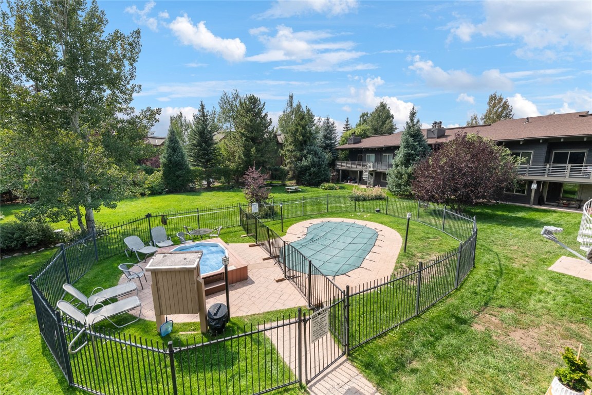 1355 Walton Creek Road, Unit 20 Steamboat Springs, CO 80487 - Photo 40 of 43 a view of a house with backyard sitting area and garden