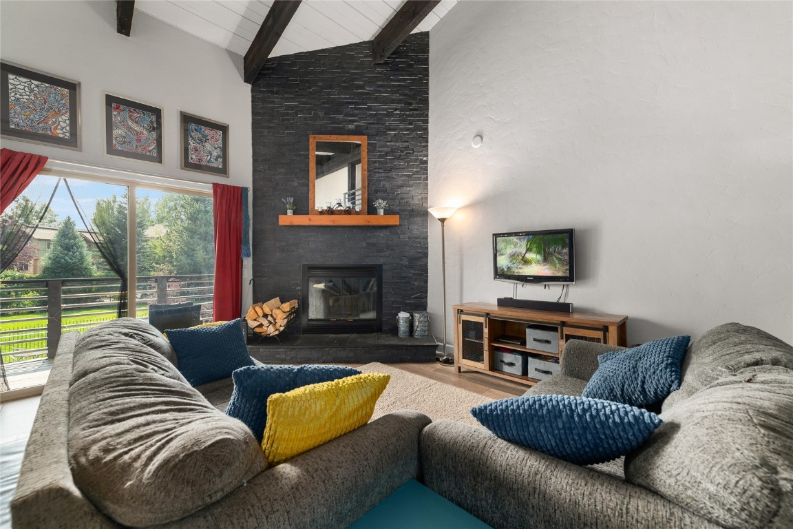 1355 Walton Creek Road, Unit 20 Steamboat Springs, CO 80487 - Photo 5 of 43 a living room with furniture and a fireplace