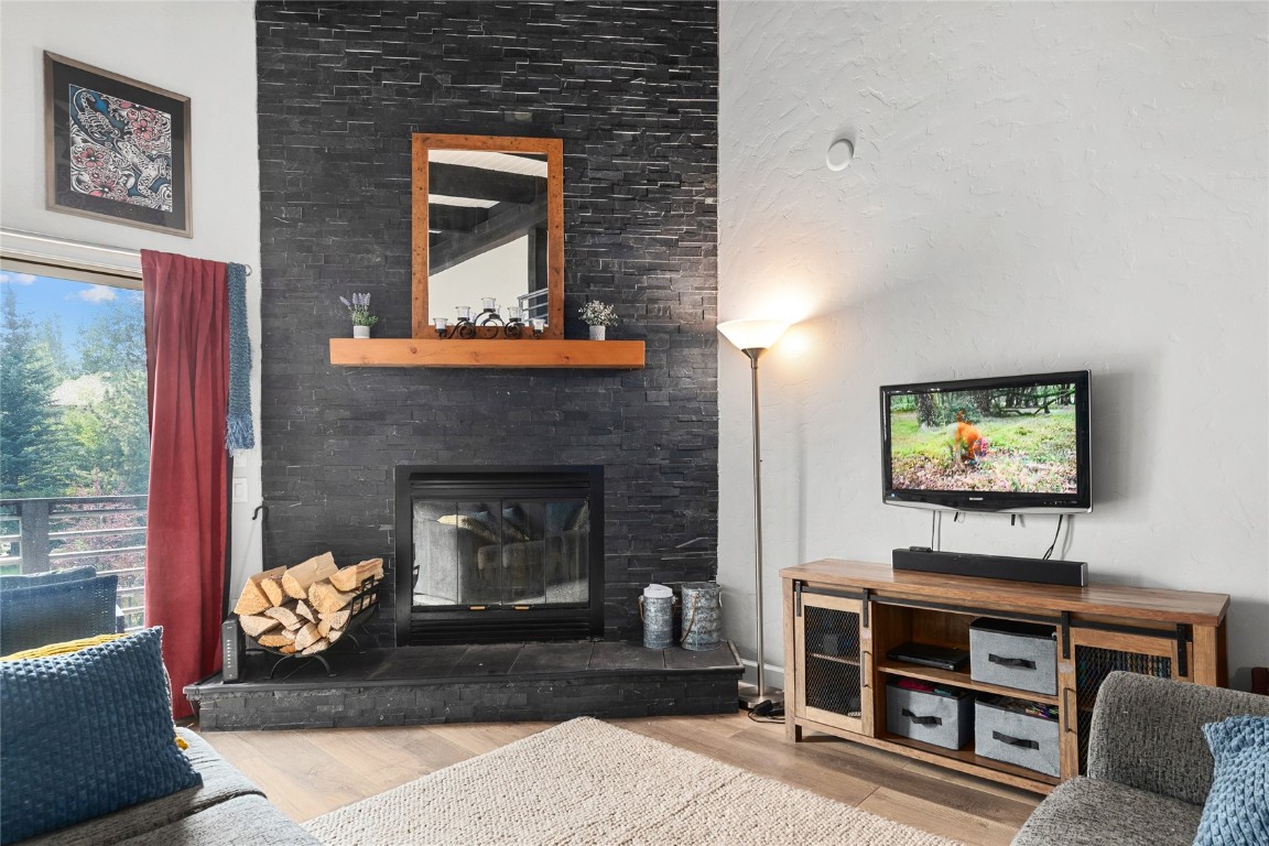 1355 Walton Creek Road, Unit 20 Steamboat Springs, CO 80487 - Photo 6 of 43 a living room with furniture and a fireplace