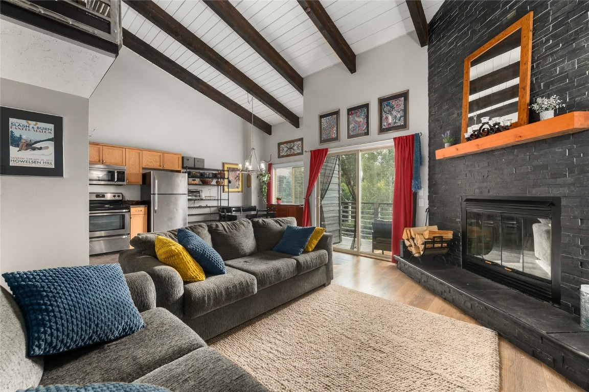 1355 Walton Creek Road, Unit 20 Steamboat Springs, CO 80487 - Photo 7 of 43 a living room with furniture and a fireplace