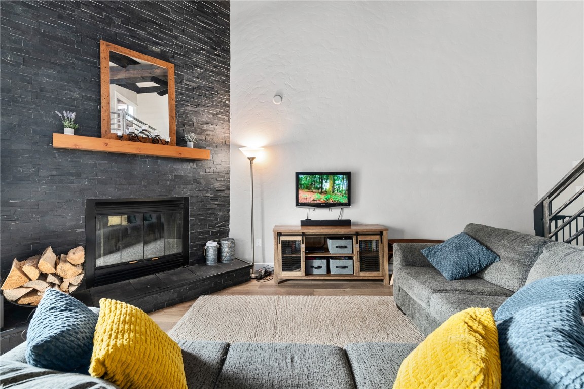 1355 Walton Creek Road, Unit 20 Steamboat Springs, CO 80487 - Photo 10 of 43 a living room with furniture and a fireplace