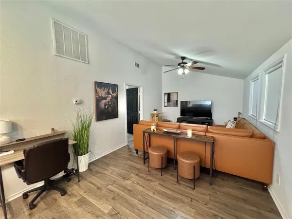 a view of a livingroom with workspace and a window
