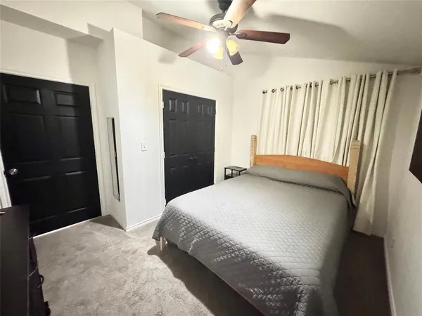 a bedroom with a bed and a large mirror