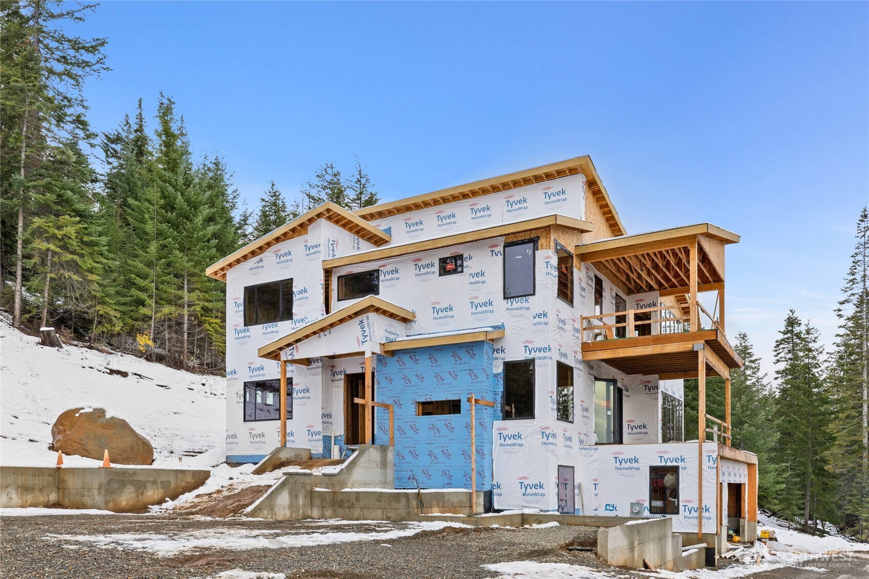901 Whisper Creek Drive Cle Elum, WA 98922 - Photo 1 of 31 a view of a white house with large windows and a small yard