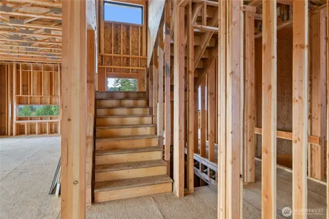a view of a porch with wooden floor and iron stairs