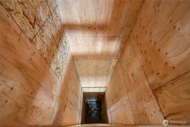 an aerial view of residential houses with outdoor space and trees