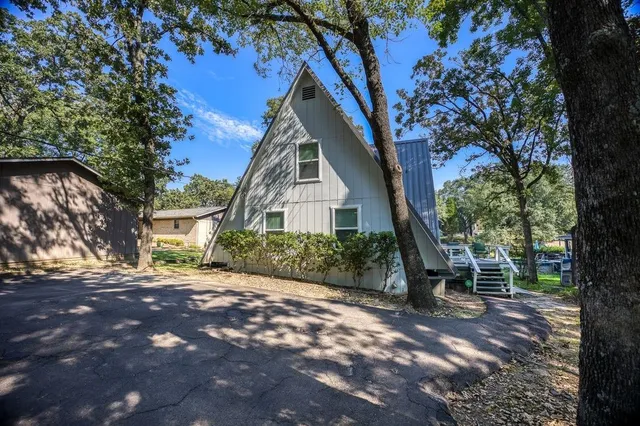 a living room with furniture large window and flat screen tv