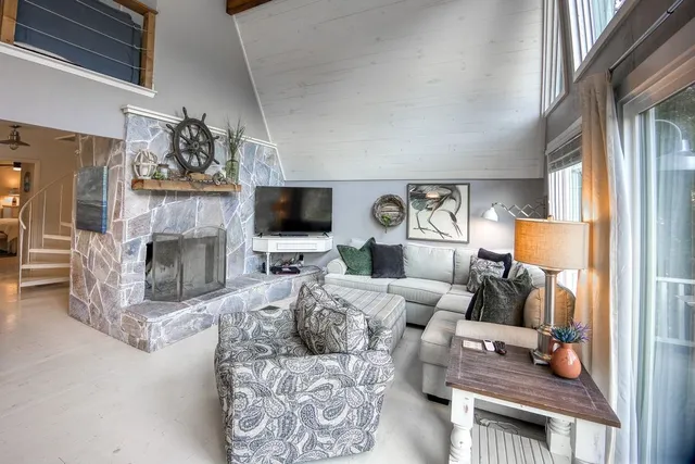 a living room with furniture a fireplace and a flat screen tv