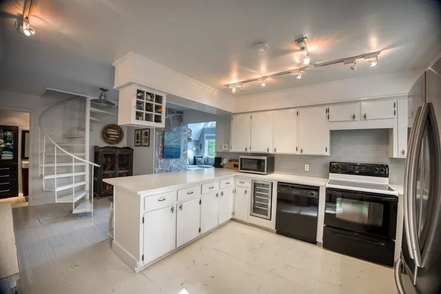 a spacious bedroom with a bed a couch and dresser