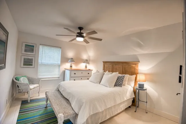 a bedroom with furniture and wooden floor