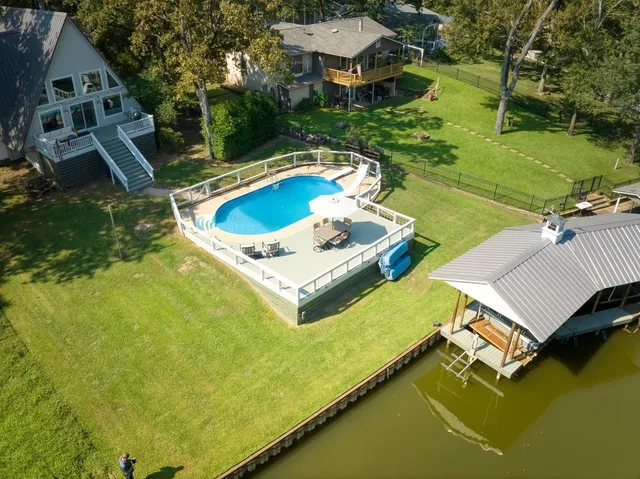 a view of swimming pool with chairs and table in patio