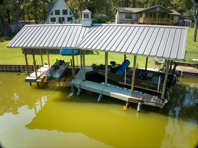 a view of a house with pool and chairs