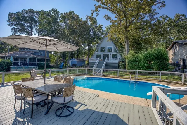 swimming pool view with a seating space and a view of a swimming pool