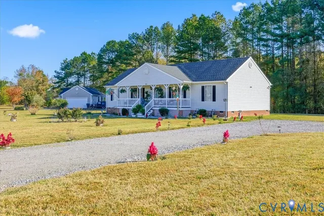 a view of swimming pool with seating area and trees in the background